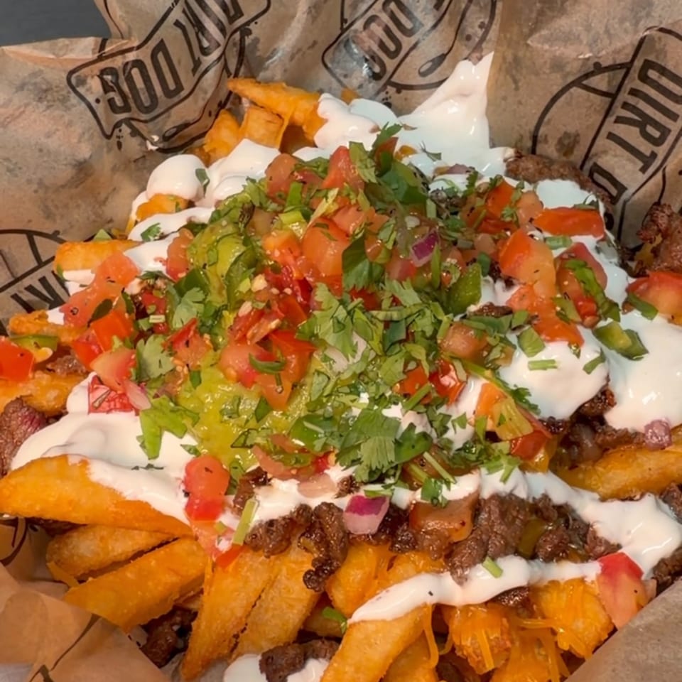 Loaded fries with ground beef, cheese, sour cream, guacamole, pico de gallo, and cilantro.